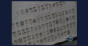 A screenshot showing a large poster of mugshots displayed during a 2018 press conference about federal indictments targeting the Mexican Mafia