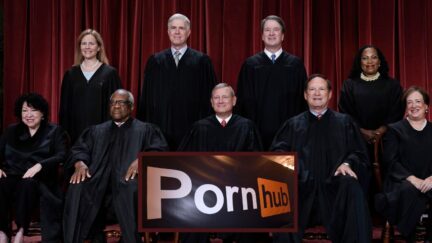 Main: FILE - Members of the Supreme Court sit for a group portrait following the addition of Associate Justice Ketanji Brown Jackson, at the Supreme Court building in Washington, Oct. 7, 2022. Bottom row, from left, Associate Justice Sonia Sotomayor, Associate Justice Clarence Thomas, Chief Justice of the United States John Roberts, Associate Justice Samuel Alito, and Associate Justice Elena Kagan. Top row, from left, Associate Justice Amy Coney Barrett, Associate Justice Neil Gorsuch, Associate Justice Brett Kavanaugh, and Associate Justice Ketanji Brown Jackson. (AP Photo/J. Scott Applewhite, File). Inset: Pornhub banner at the 2018 AVN Adult Entertainment Expo at the Hard Rock Hotel & Casino on January 24, 2018 in Las Vegas, Nevada (Image by Ethan Miller/Getty Images).