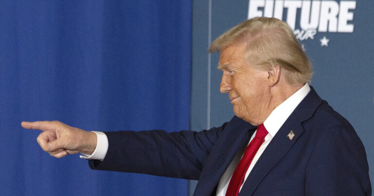 Donald Trump points to the left.