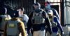 FILE - Law officials spread out through an apartment complex during a raid, Feb. 5, 2025, in east Denver (AP Photo/David Zalubowski, File).